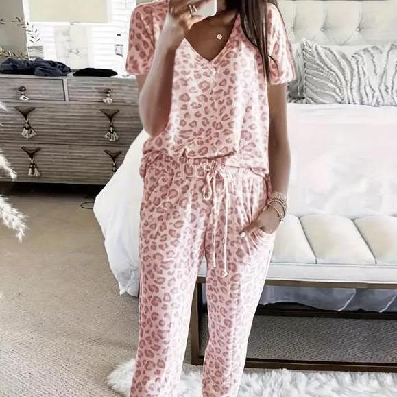 Women's V-NeckLeopard Print Loungewear Set. This relaxed-fit two-piece features a short-sleeve top and pants for effortlessly chic, casual comfort.